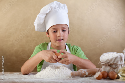 Photo: Little chef preparing the dough for cookies Little chef preparing the dough for cookies