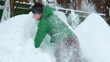 Young man fighting with pile of snow.