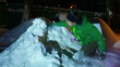 Young man fighting with pile of snow.