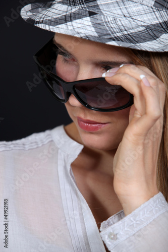 Photo: Woman wearing hat and sunglasses Woman wearing hat and sunglasses