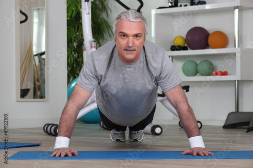 Photo: Mature man doing pushups Mature man doing pushups