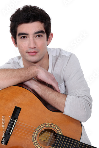 Photo: A man with a guitar. A man with a guitar.