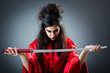 Female sword warriod in dark studio