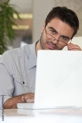 Photo: Man with glasses in front of computer Man with glasses in front of computer