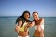 two girlfriends having fun on the beach