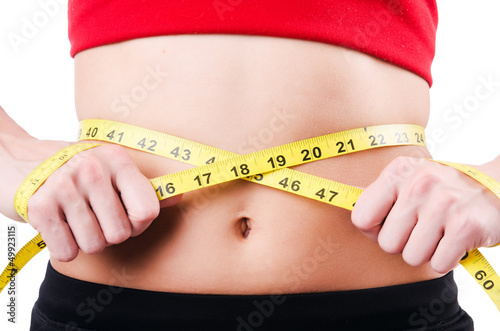 Photo: Young girl with centimeter in dieting concept Young girl with centimeter in dieting concept