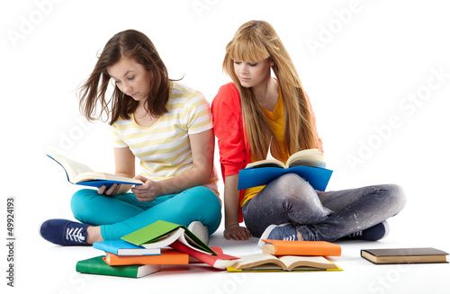 Photo: Two Teenage Girls reading The Book.Education Two Teenage Girls reading The Book.Education