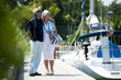 Mature couple enjoying a stroll at a marina