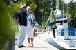 Mature couple enjoying a stroll at a marina