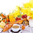 Breakfast with rolls, coffee, egg, orange juice and fruits