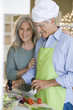 Mature couple preparing food