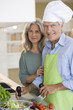 Mature couple preparing food