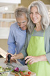 Mature couple preparing food