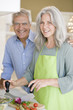 Mature couple preparing food