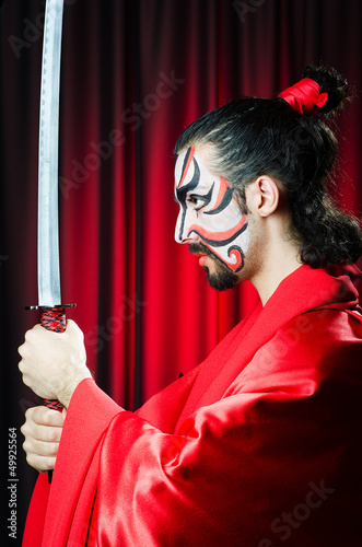 Photo: Man with sword and face mask Man with sword and face mask