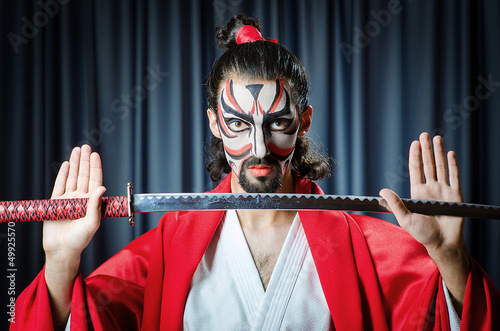 Photo: Man with sword and face mask Man with sword and face mask