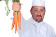 chef holding a bunch of carrots