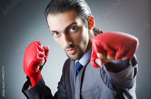 Photo: Businessman with boxing gloves on white Businessman with boxing gloves on white
