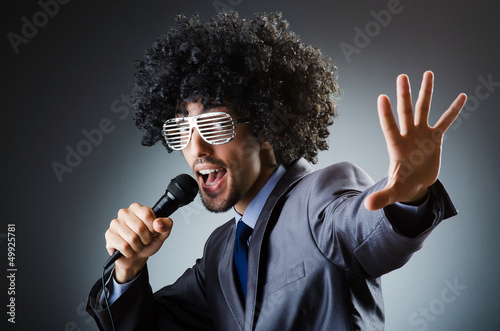 Photo: Man with afro haircut singing in studio Man with afro haircut singing in studio