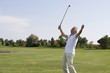 Mature man playing golf