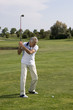 Mature man playing golf