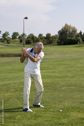 Photo: Mature man playing golf Mature man playing golf