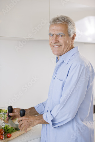 Photo: Mature man preparing food Mature man preparing food