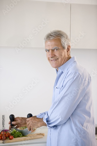 Photo: Mature man preparing food Mature man preparing food