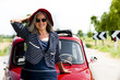 Photo: Mature woman enjoying a road trip in a small red car Mature woman enjoying a road trip in a small red car