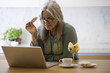 Photo: Mature woman with laptop computer Mature woman with laptop computer