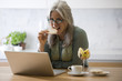Photo: Mature woman with laptop computer Mature woman with laptop computer