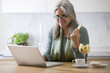Photo: Mature woman with laptop computer Mature woman with laptop computer