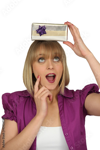Photo: Excited woman holding mystery gift Excited woman holding mystery gift