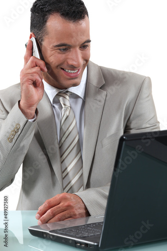 Photo: businessman working at his desk businessman working at his desk