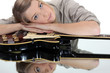 Woman leaning on a guitar