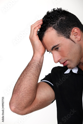 Photo: Man suffering from a throbbing headache Man suffering from a throbbing headache