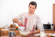 Young man preparing a cake