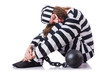 Prisoner in striped uniform on white