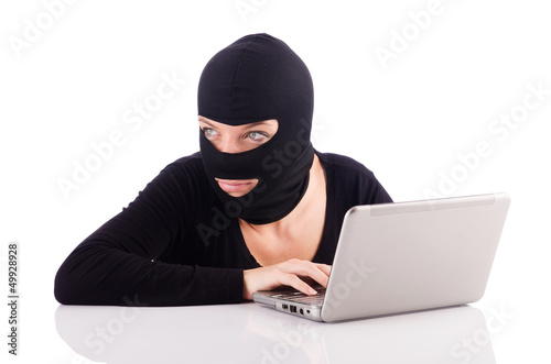 Photo: Hacker with computer wearing balaclava Hacker with computer wearing balaclava