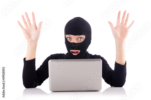 Photo: Hacker with computer wearing balaclava Hacker with computer wearing balaclava