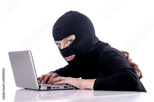 Photo: Hacker with computer wearing balaclava Hacker with computer wearing balaclava