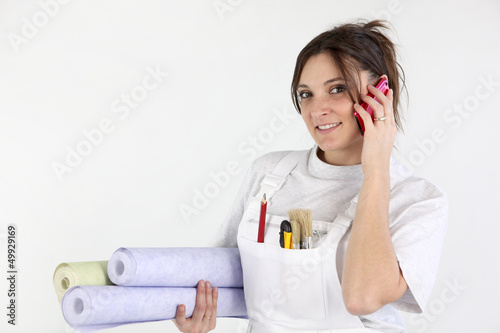 Photo: Decorator carrying rolls of wallpaper Decorator carrying rolls of wallpaper