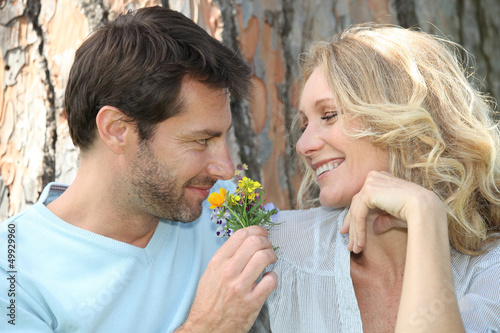 Photo: couple leaning on tree couple leaning on tree