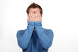 Man covering his face