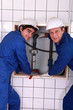 Plumber with young apprentice