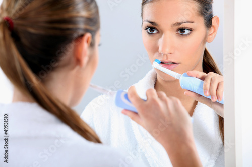 Photo: Woman with an electric toothbrush Woman with an electric toothbrush