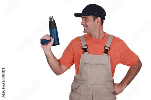 Photo: craftsman holding a heat gun craftsman holding a heat gun
