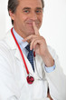Male doctor holding finger to his mouth