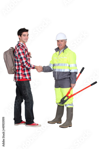 Photo: A construction worker and his grandson. A construction worker and his grandson.