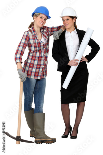 Photo: Blue collar worker standing next to an engineer Blue collar worker standing next to an engineer